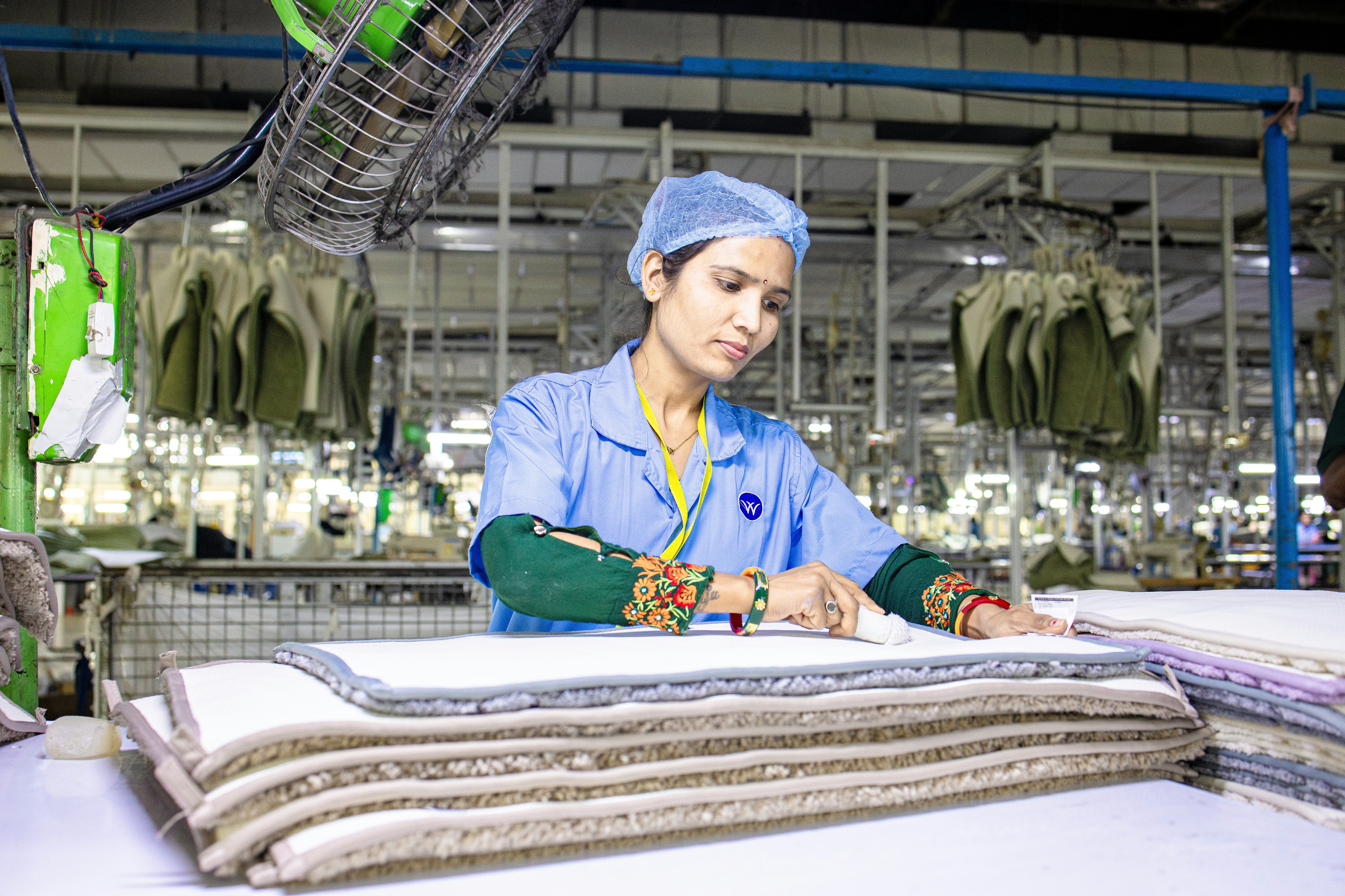 Quality control inspector checking textile fabric in factory